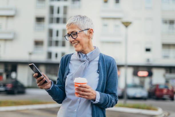 istock Senior woman usigg her smartphone 1058953686