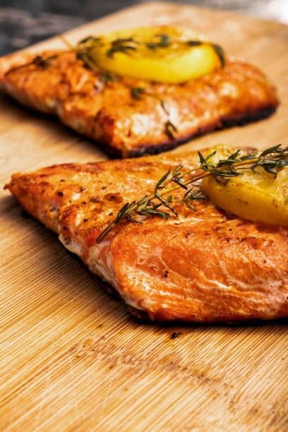 istock Lemon topped grilled salmon on a rustic cutting board 1058964438
