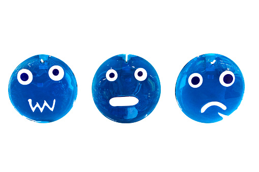 Group of blue glass emojis on white background.