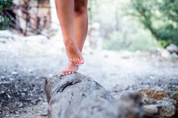 istock hippies Girl standing on a large stump 1058978148