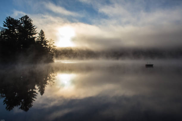 istock misty sunrise on lake 1058984500