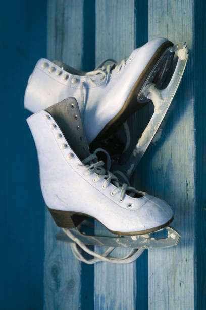 istock White ice skates on an old wooden board 1058985934