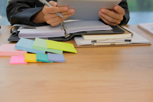 istock man organizing plan with tablet. businessman working at workplace 1058986332