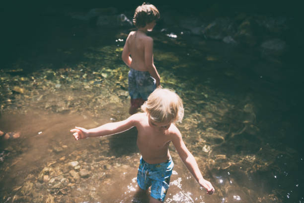 istock Children play and splash in creek 1058987458