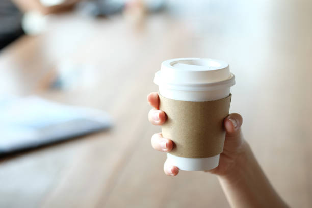 istock Hand holding brown paper cup. 1058987966