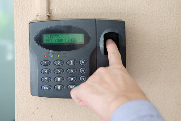 istock Man hand using biometric fingerprint scanner for track employee hours. 1058990722