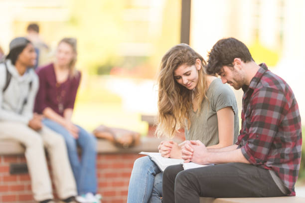 istock College students praying outside on campus 1058992180