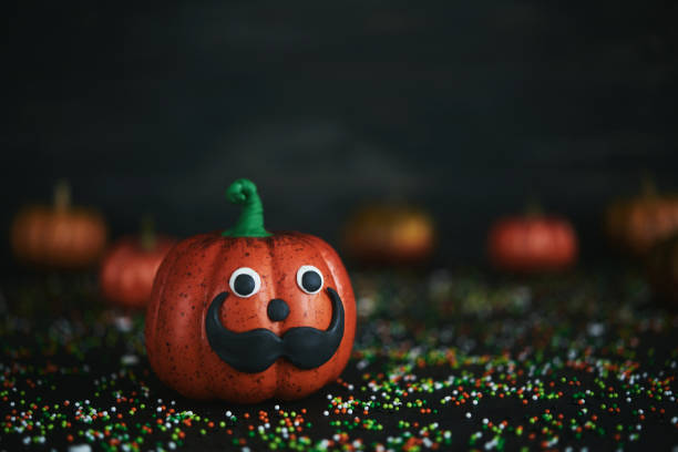 istock Halloween background with mustache face pumpkin character 1059016266