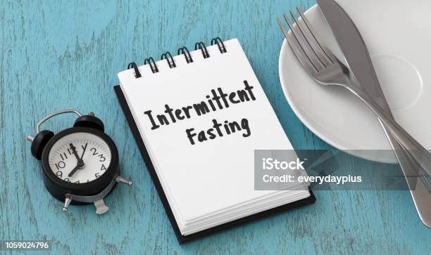 Intermittent Fasting Concept On Blue Table Stock Photo - Download Image Now - Intermittent Fasting, Fasting - Activity, Concepts