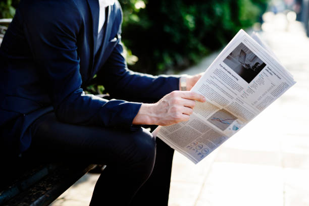 Businessman reading newspaper in the morning