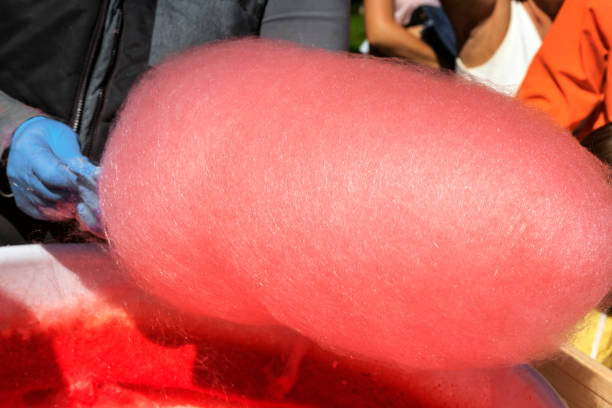 istock Cooking cotton candy on the street. Close-up 1059032948