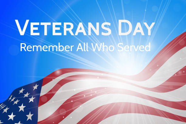 istock Veterans Day, honoring all those who served the poster with a waving US flag against a blue sky and bright shining sun 1059039430