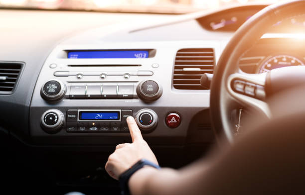 woman push turn on air condition in car - air vehicle audio imagens e fotografias de stock