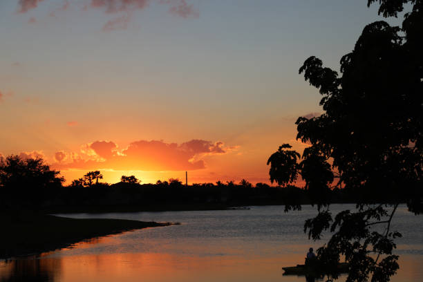 istock Sunset over the lake, trees reflection in water. 1059050046
