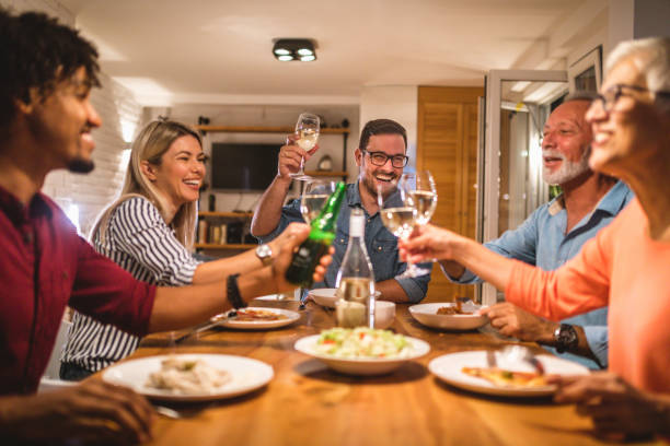 istock Cheerful family dining and greeting guests 1059053242