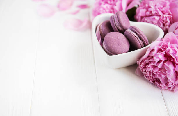 istock Pink peony flowers with macarons 1059057810