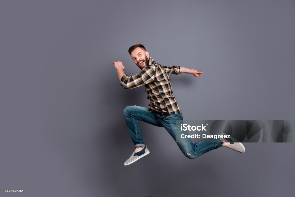 Full length, legs, body, size portrait of  running marathon man who looks in camera isolated on gray background Men Stock Photo