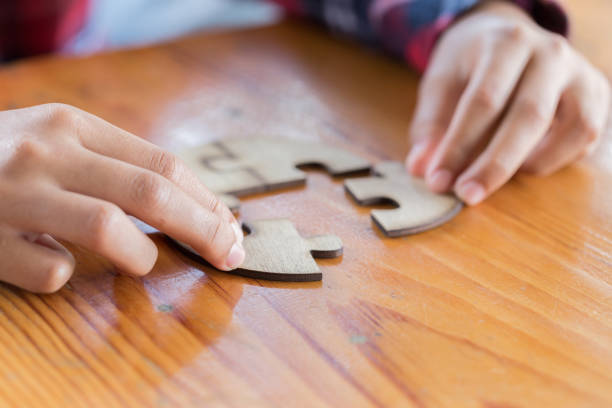 istock Closeup hand of man connecting jigsaw puzzle with sunlight effect, Business solutions, success and strategy concept 1059061404