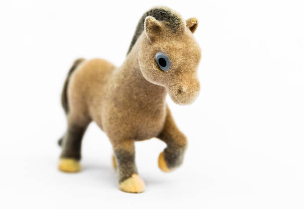 Little figurine of a brown pony on a white background.