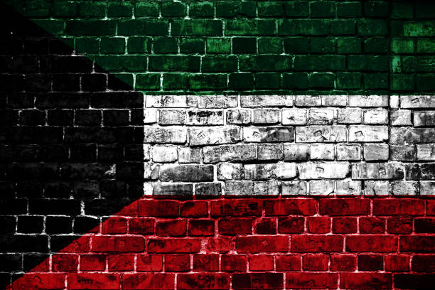 istock National flag of Kuwait on a brick background. 1059066488