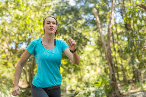 istock Fit Woman Running Outdoors While Wearing a Fitness Tracker 1059069186