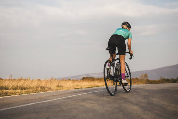 istock Strong female cyclist on the road. Copy space. 1059070706