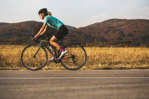 istock Young woman rides racing bicycle 1059070808