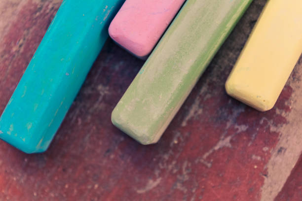 istock Retro colored chalk sticks on old wood board as copy space background 1059071642