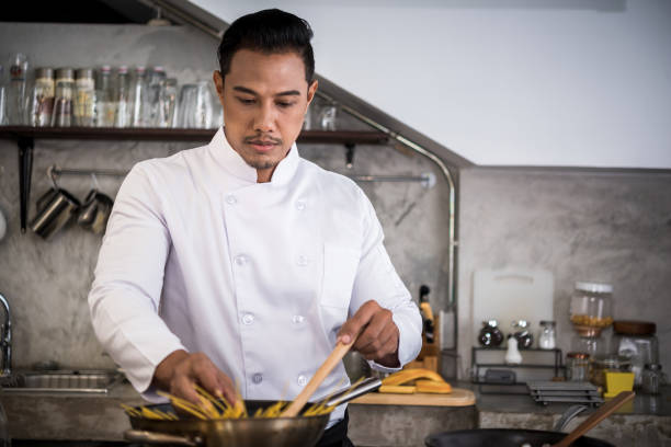 istock Chef preparing food in the kitchen of a restaurant 1059074568