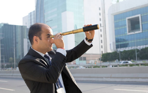 istock Businessman searching through telescope 1059074690