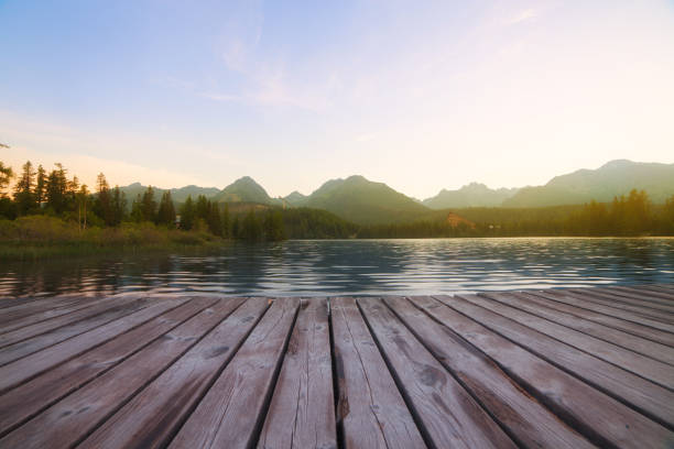 istock Forest Alpine mountain lake and wooden board background 1059076852