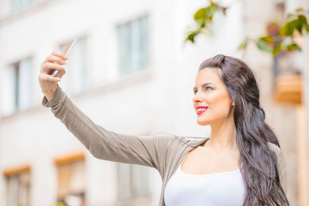 istock Cute young woman using cellphone in urban surroundings. 1059079228