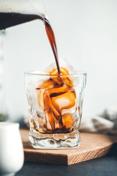 istock Coffee is pouring with a glass with ice cubes. 1059082984