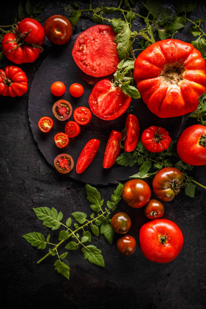 istock Whole red tomatoes and slice of tomatoes 1059083190