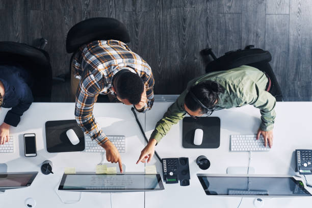 Our agents always know what to do High angle shot of a group of call centre agents working in an office it support stock pictures, royalty-free photos & images