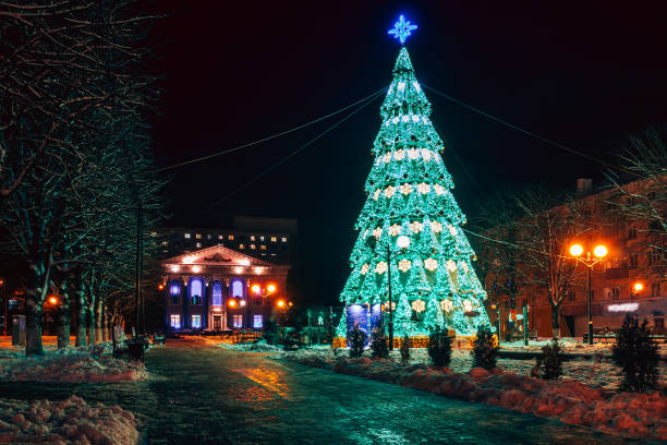 istock Beautiful urban Christmas tree in green illumination. 1059091298