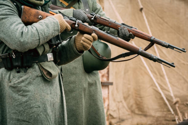 Two Soldiers of the Wehrmacht with rifles in their hands Soldiers of the Wehrmacht in greatcoats with rifles in their hands ready to shoot historical reenactment stock pictures, royalty-free photos & images