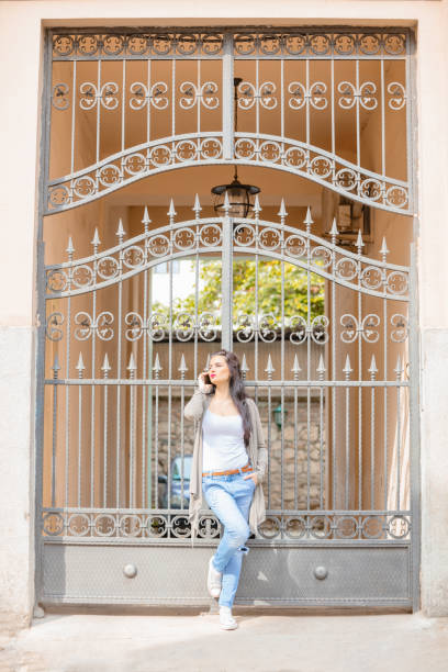 istock Cute young woman using cellphone in urban surroundings. 1059094116