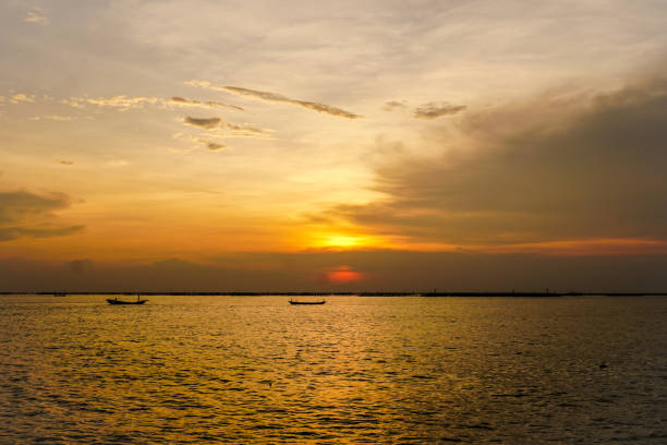 istock Small fishing boat with sunset light 1059094702
