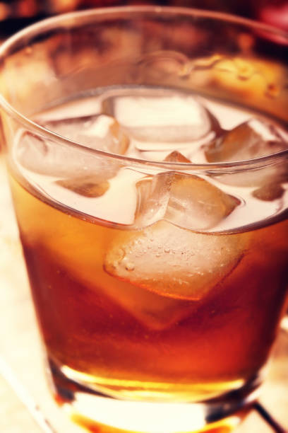 istock Cold alcoholic drink with ice on rustic vintage background 1059096936