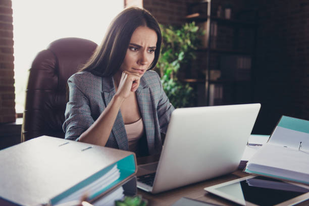 istock Elegant classic nice charming cute trendy overwhelmed lady boss, wearing grey jacket, reading business plan, project start up at modern loft work place, station. Document pile, stack, bureaucracy 1059104300