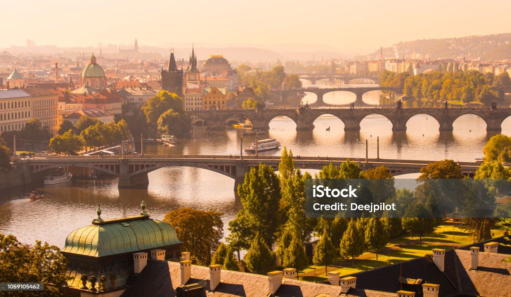 Aerial View of the the Charles Bridge and Vltava River in Prague, Czech Republic Warm Glow of the Sunset Over the City of Prague Prague Stock Photo