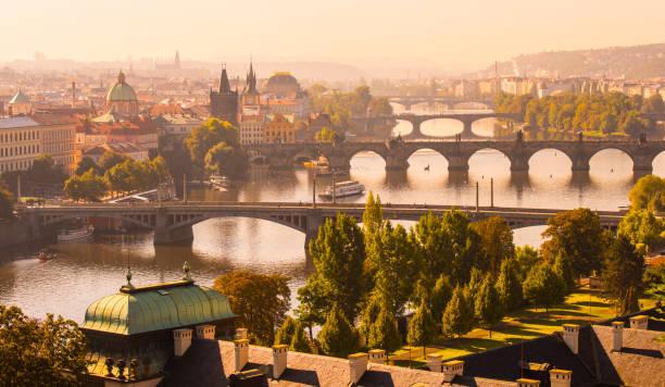 Aerial View of the the Charles Bridge and Vltava River in Prague, Czech Republic Warm Glow of the Sunset Over the City of Prague charles bridge photos stock pictures, royalty-free photos & images