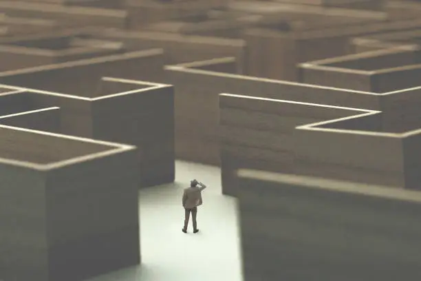 Photo of man lost in a complex maze, surreal concept