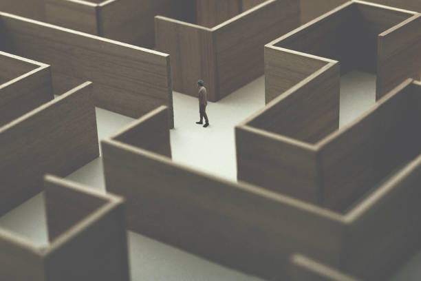 istock man walking in a complex maze, surreal concept 1059110614