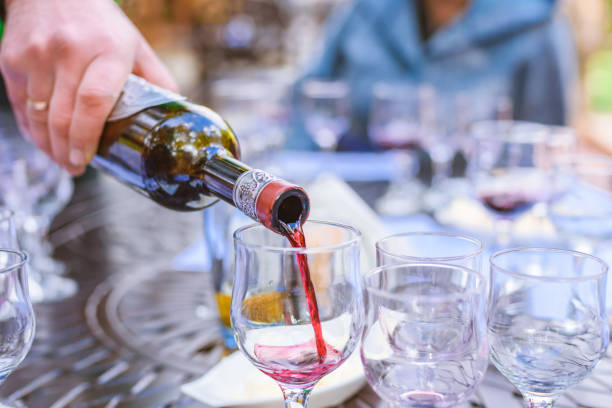 istock the sommelier spills wine in glasses on wine tasting 1059113478