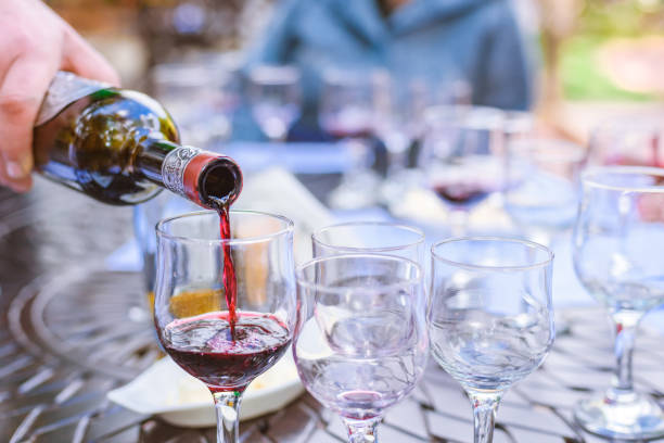 istock the sommelier spills wine in glasses on wine tasting 1059113482