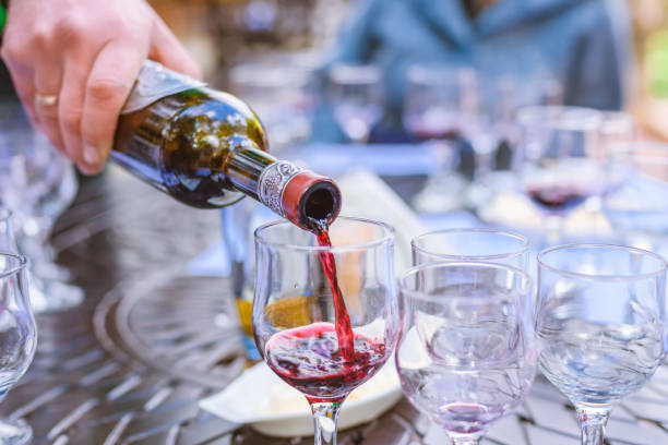 istock the sommelier spills wine in glasses on wine tasting 1059113488