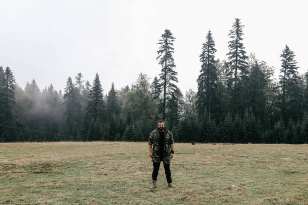 young man in military costume in forest