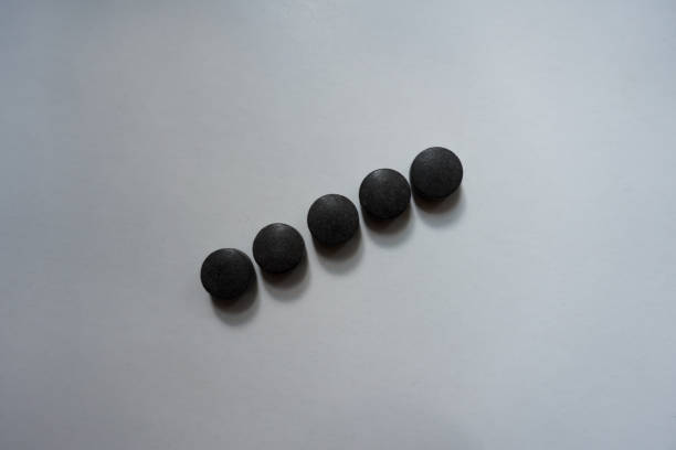 istock Line of five round black tablets of chelated iron 1059115874